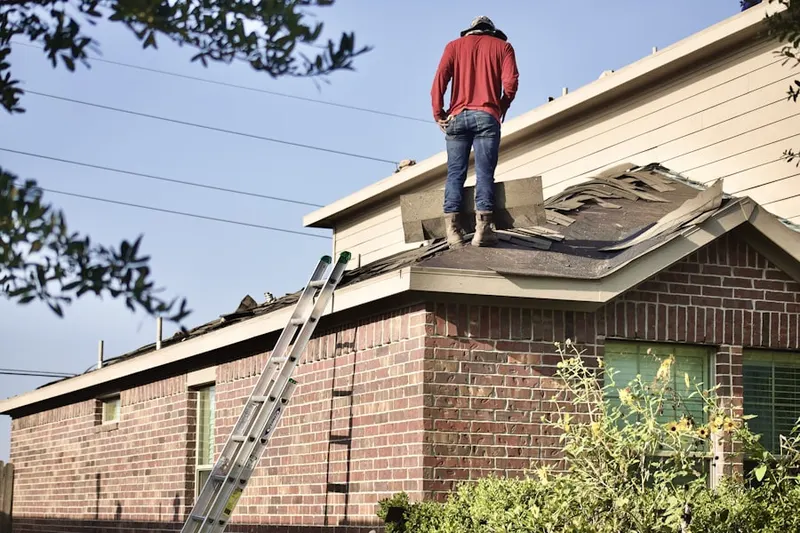 Professional roofer working on a residential roof in Venetian Golf And River Club
